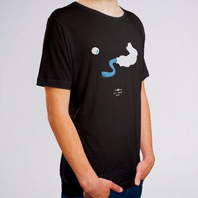 Close-up photograph of a black T-shirt worn by a boy with the Golubój drawing, a light blue oil paint tube.