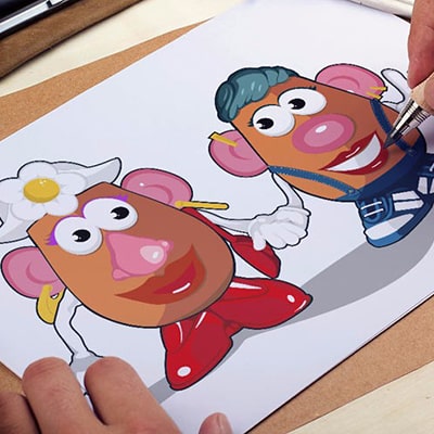 Close-up photograph of a person drawing 2 Mrs. Potato holding hands.