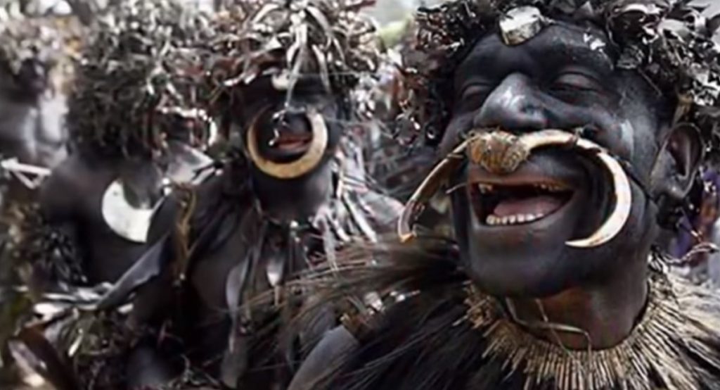 Sambia tribe dancing in group.